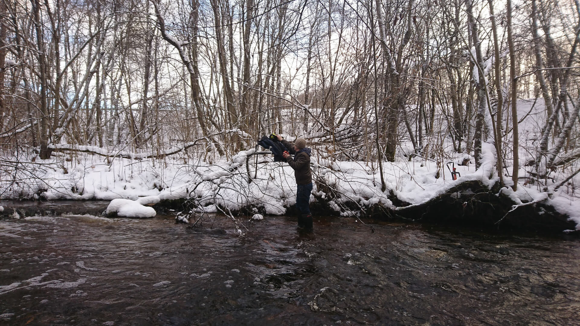 Man in a river during winter